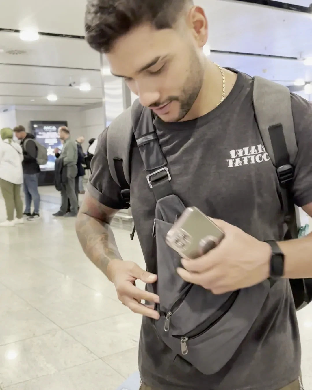 Taking a phone out of the FlyHugz Anti-Theft Bag